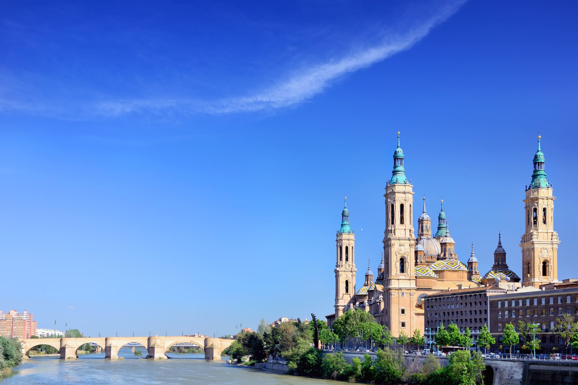 a river with a bridge and a city with towers
