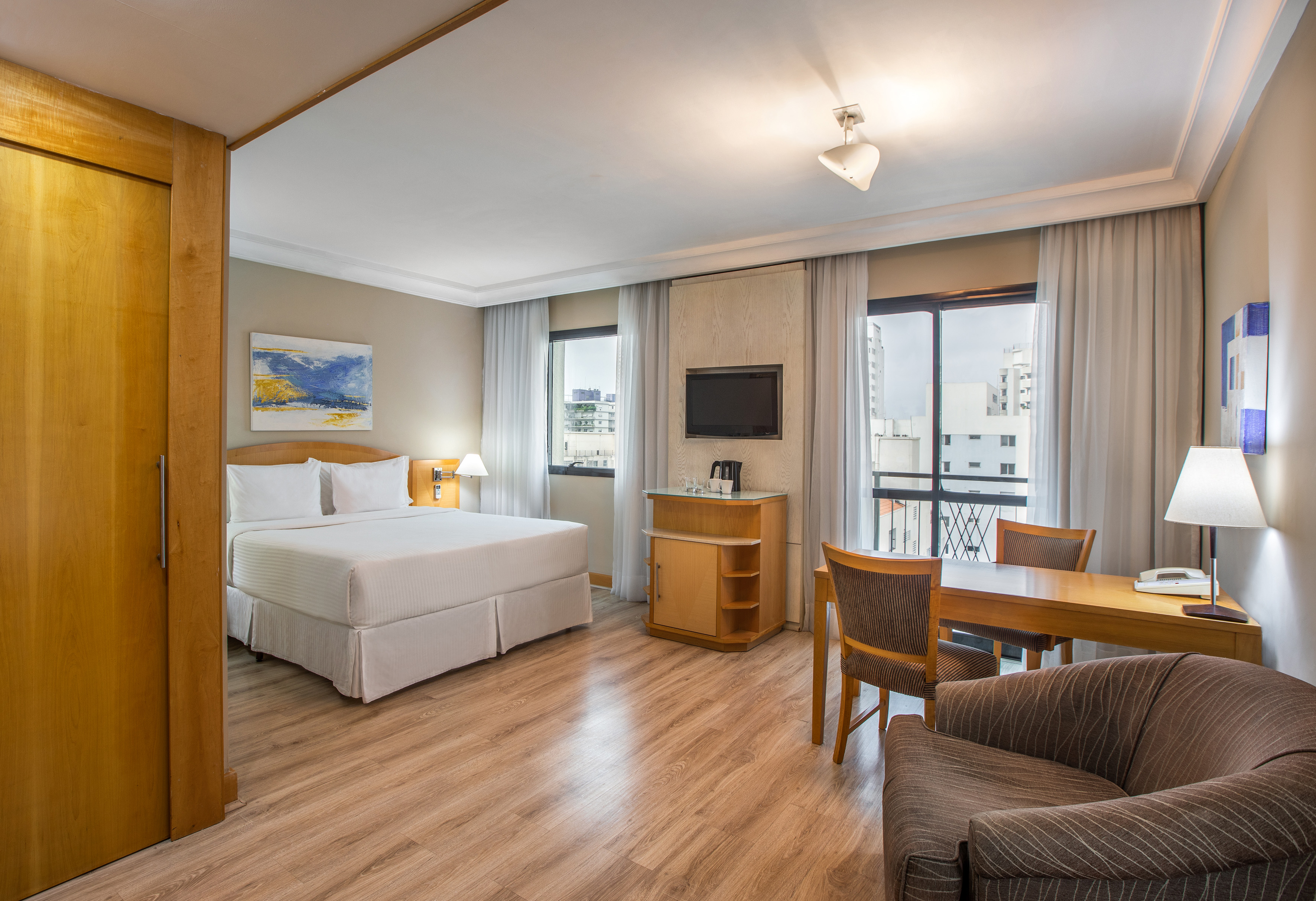 a room with a bed and a table and chairs