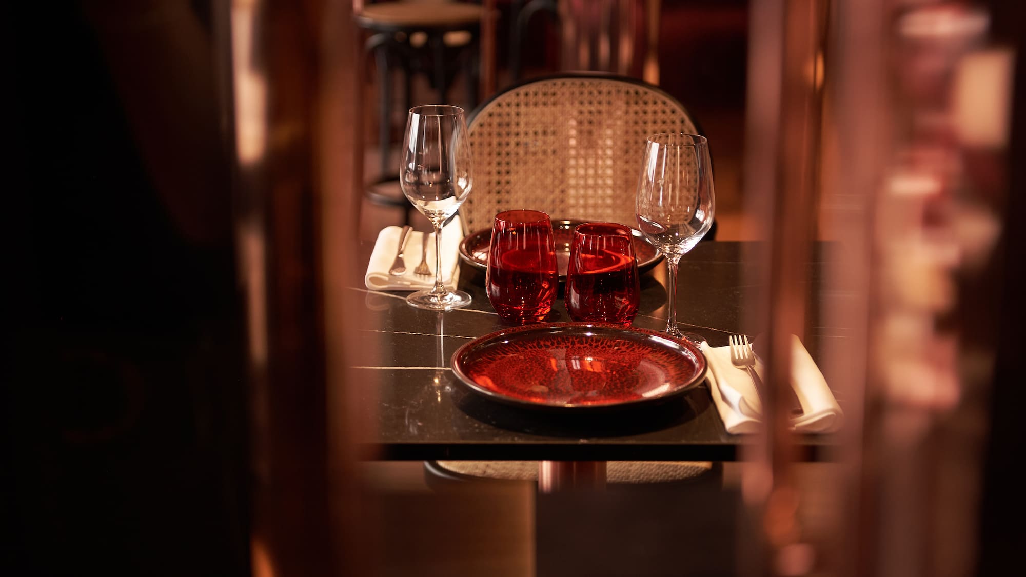 a table with wine glasses and plates