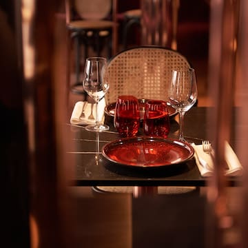 a table with wine glasses and plates