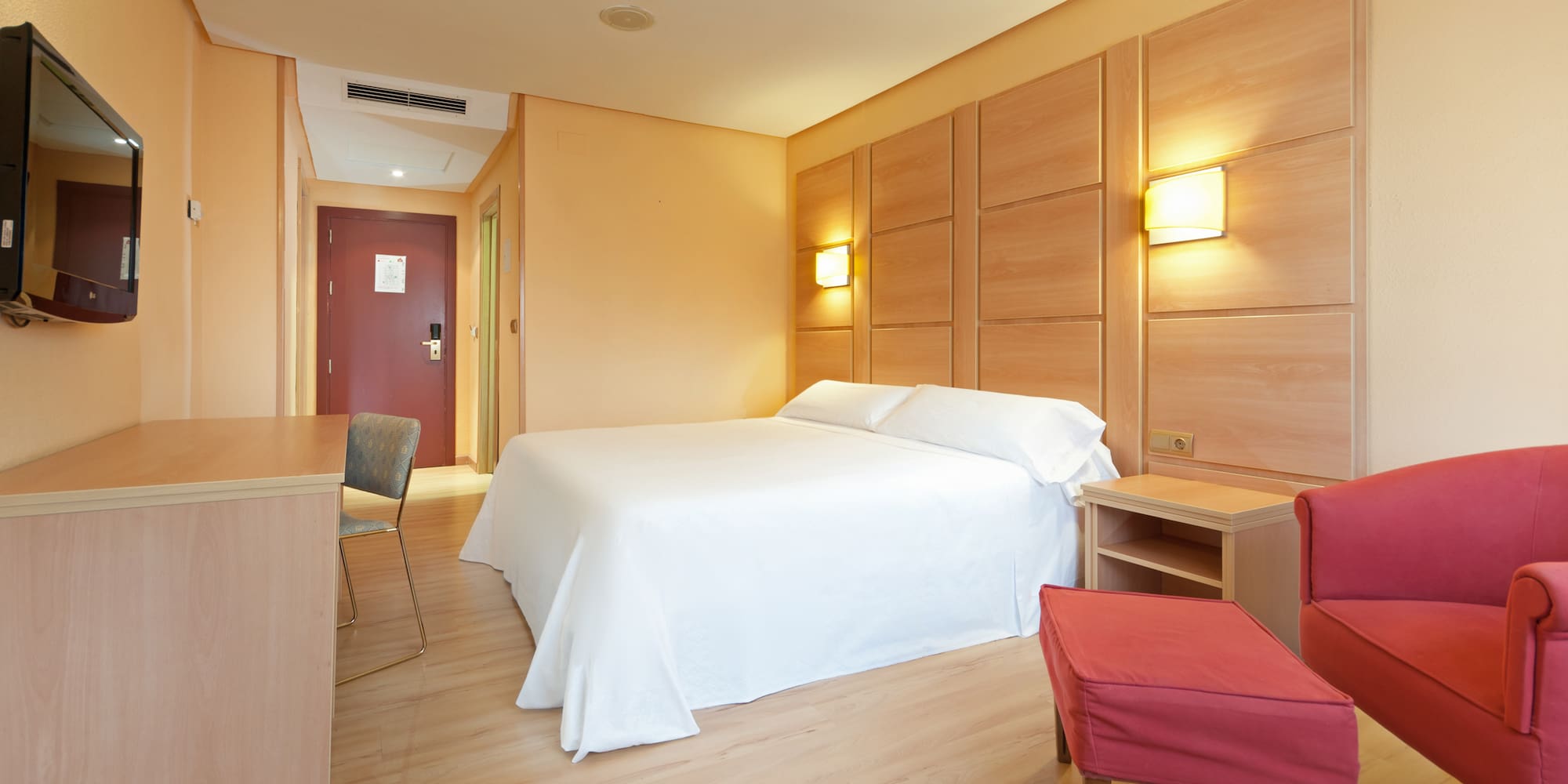 a room with a bed and a table and chairs