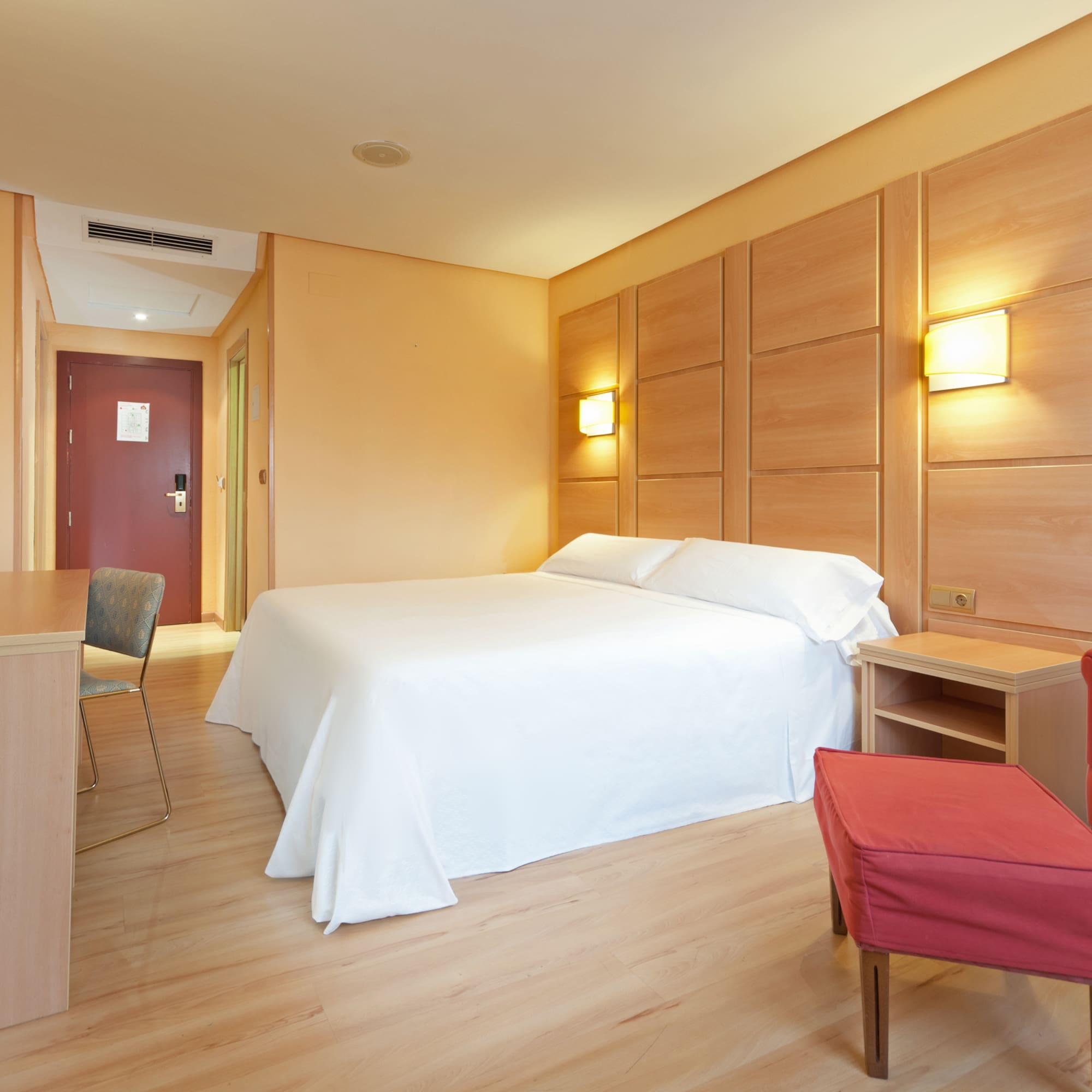 a room with a bed and a table and chairs