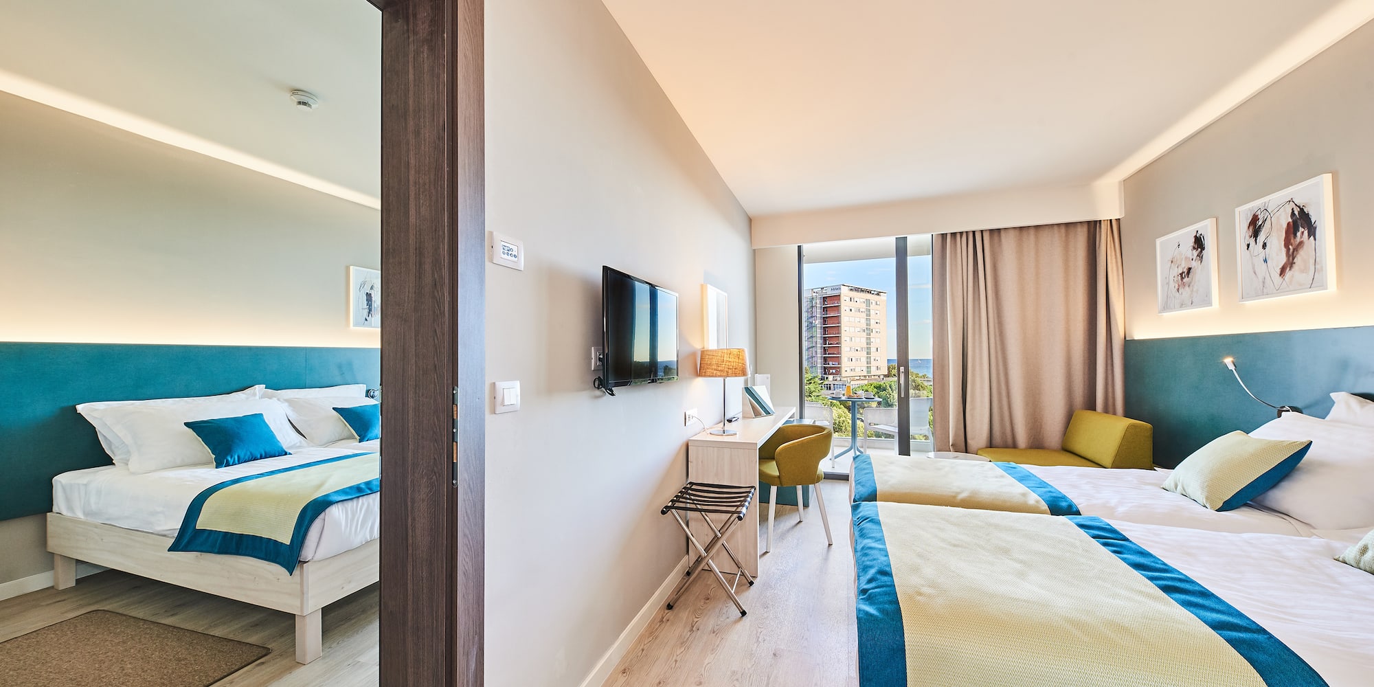 a room with two beds and a television