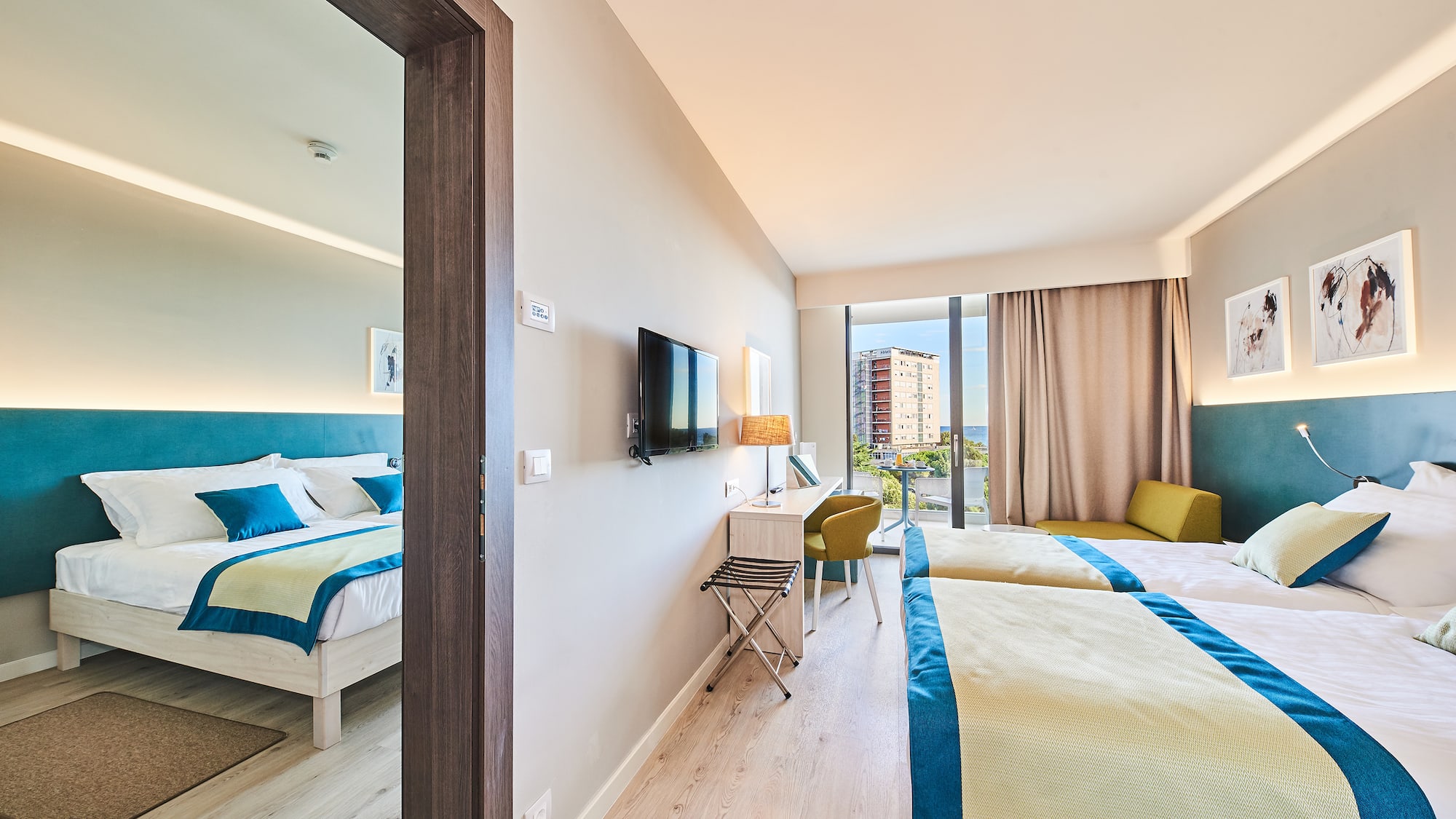 a room with two beds and a television