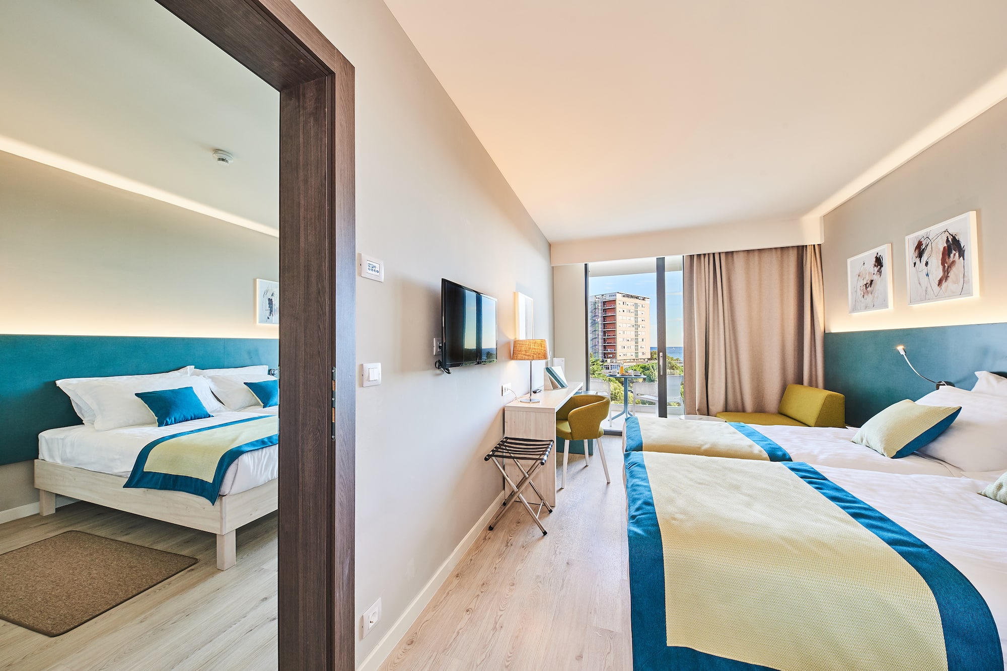 a room with two beds and a television