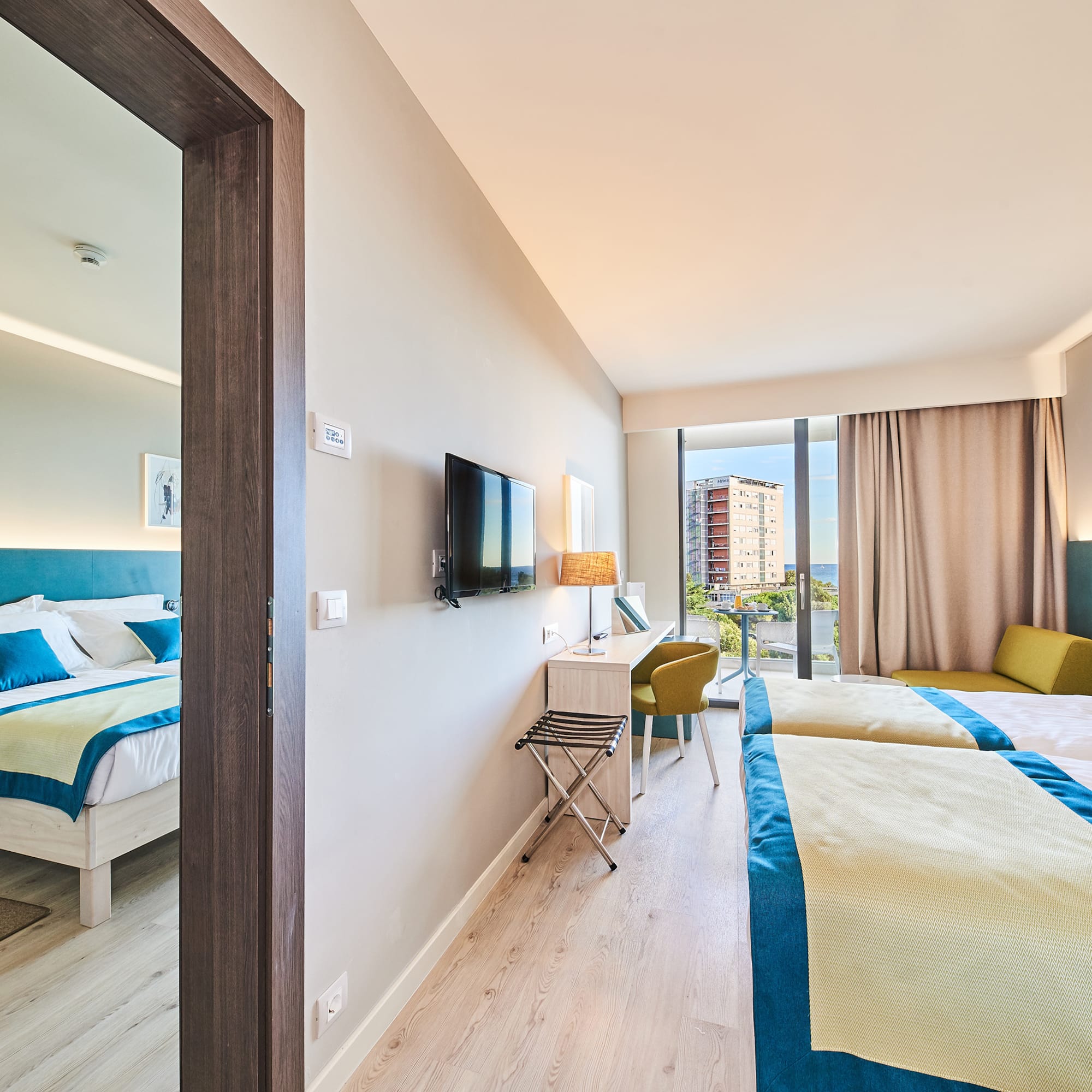 a room with two beds and a television