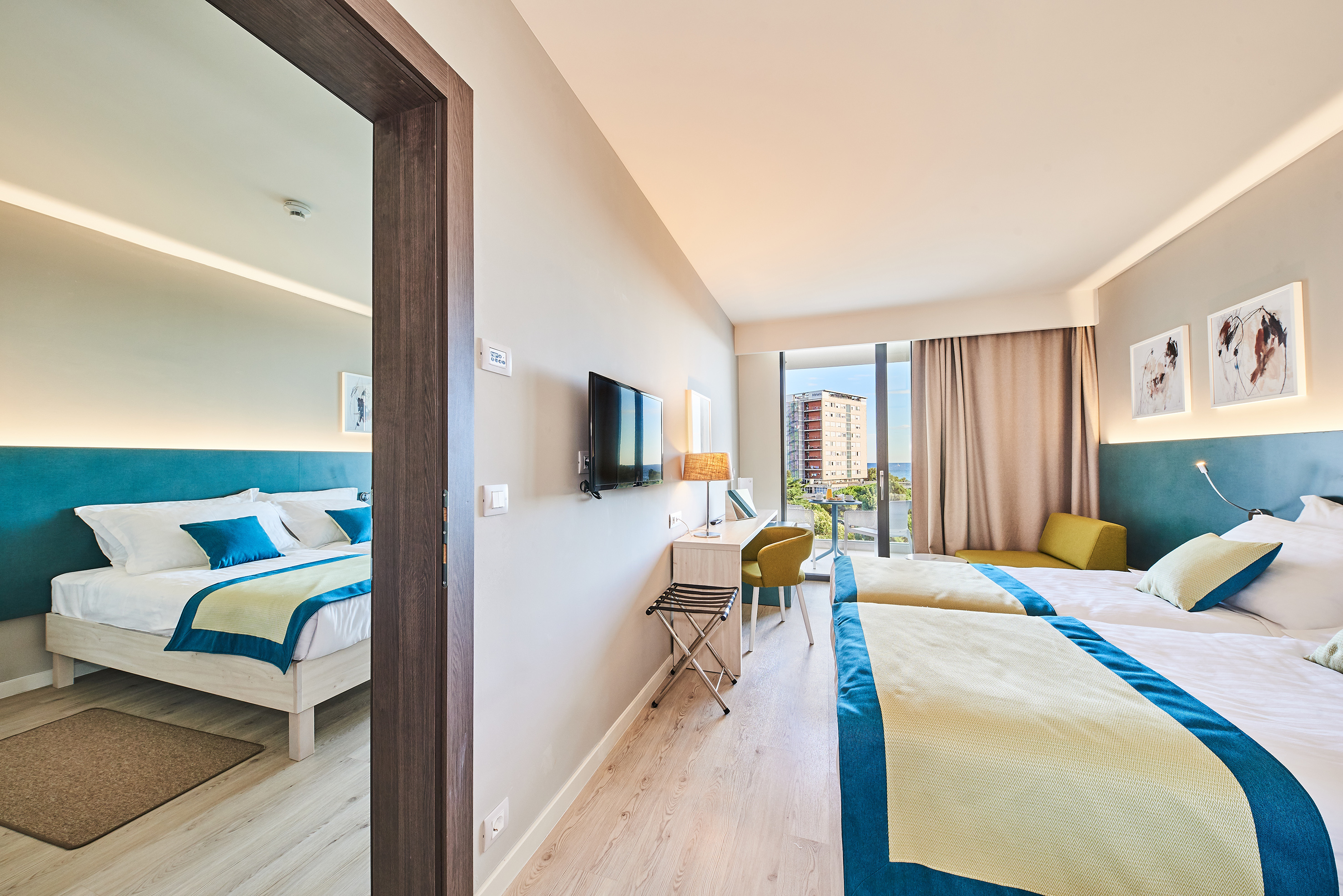 a room with two beds and a television