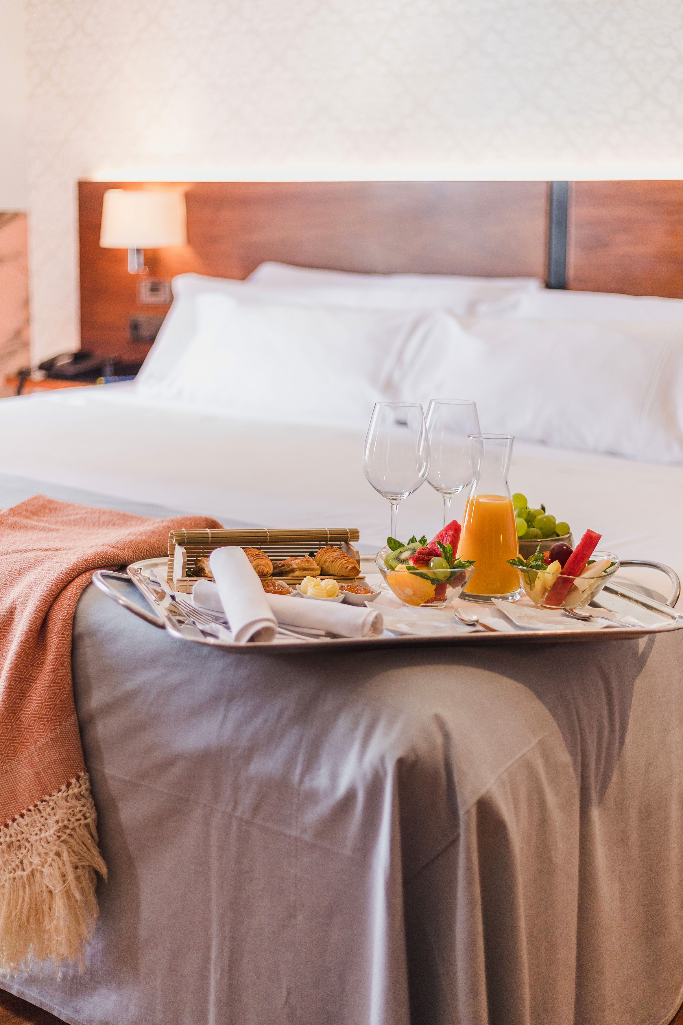 a tray of food on a bed