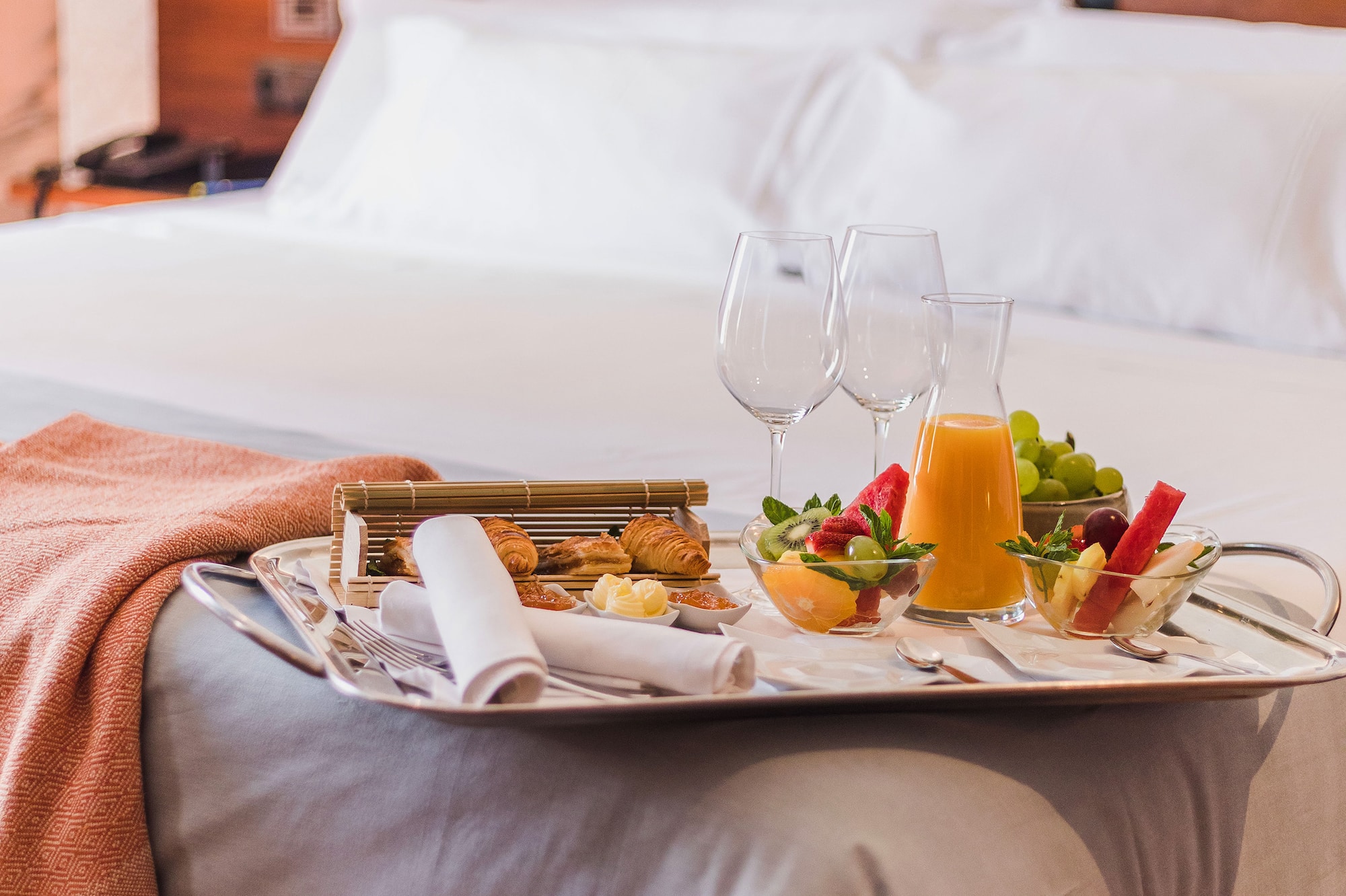 a tray of food on a bed