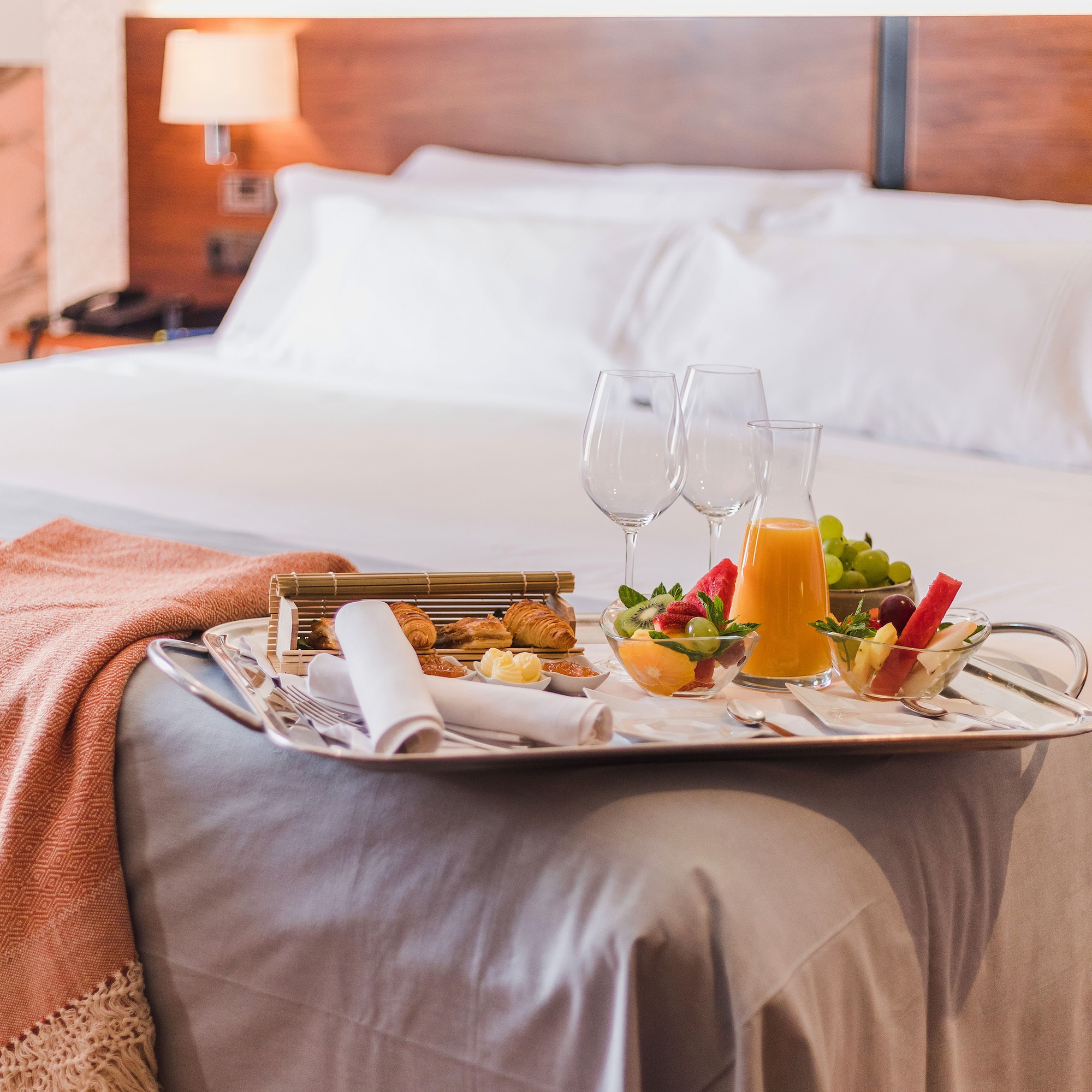 a tray of food on a bed