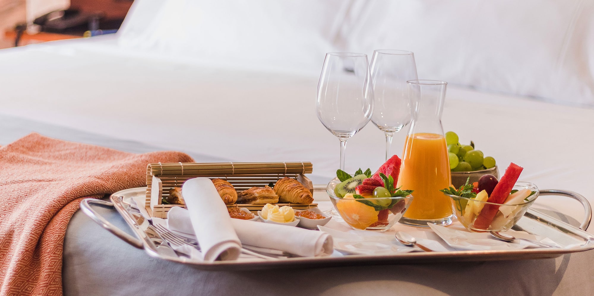 a tray of food on a bed