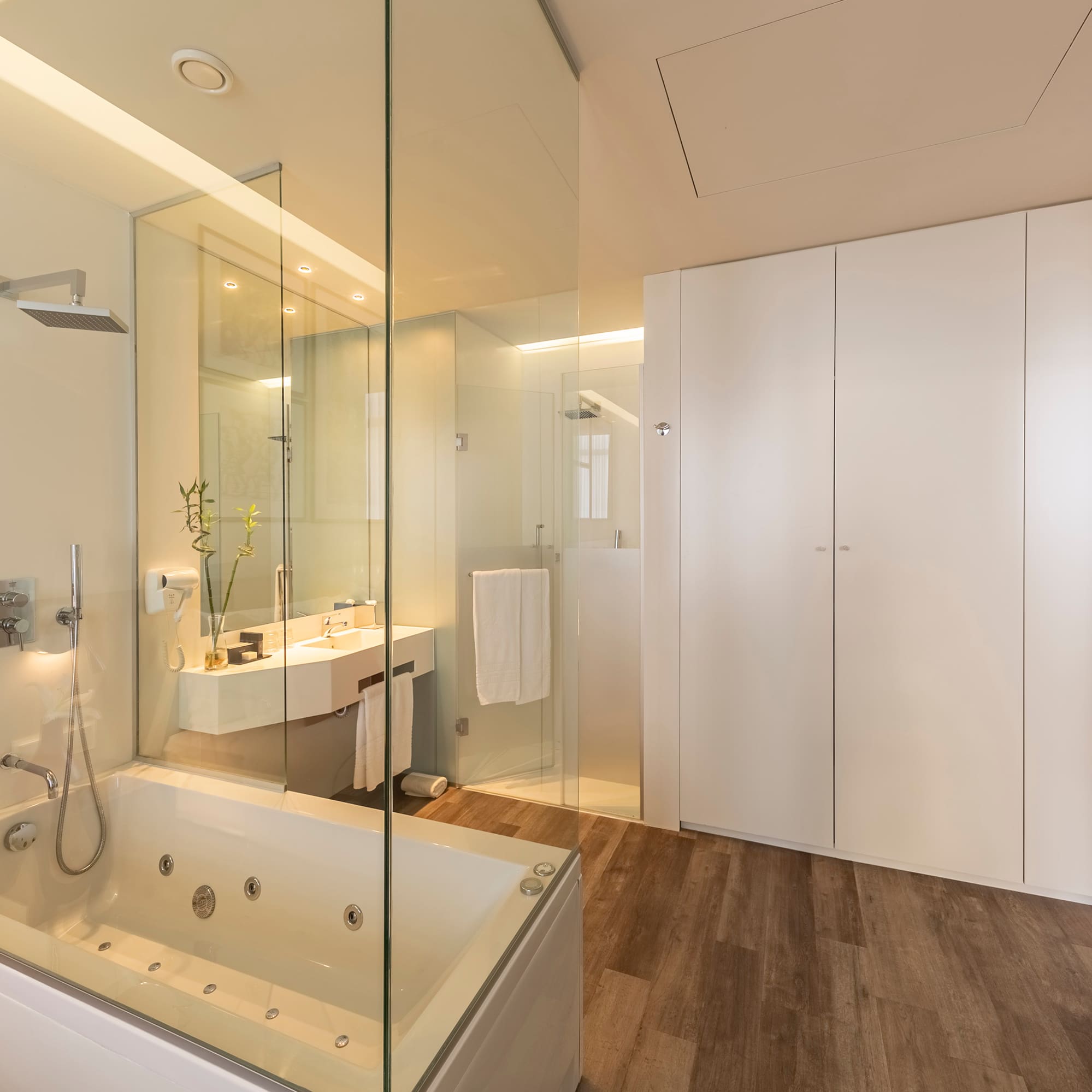 a bathroom with a glass shower and tub