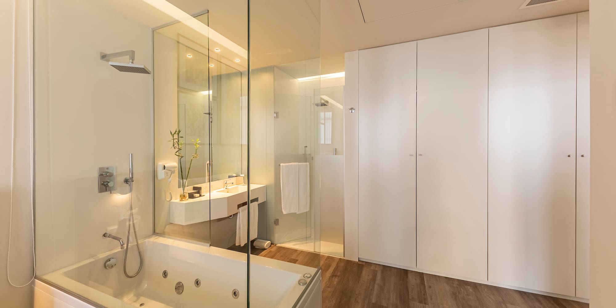 a bathroom with a glass shower and tub