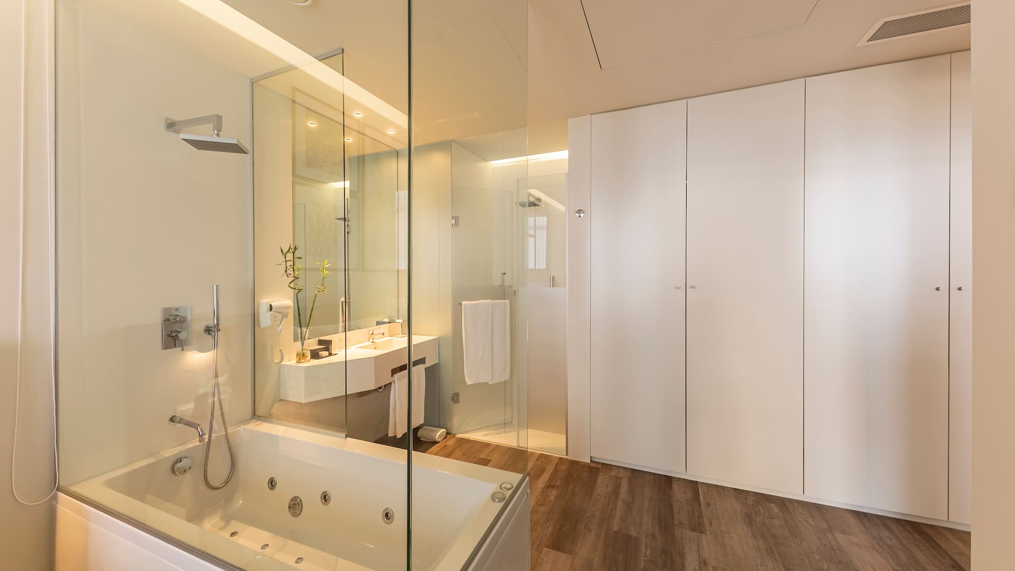a bathroom with a glass shower and tub