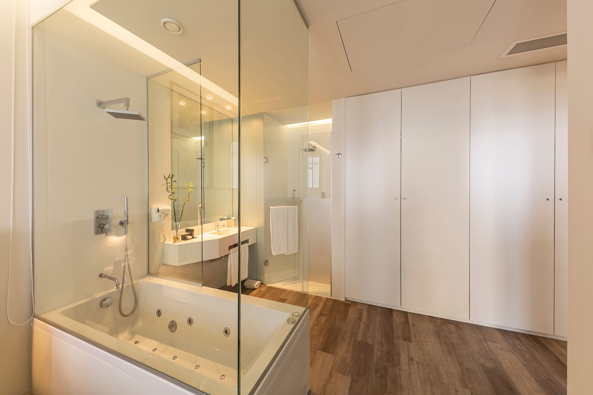 a bathroom with a glass shower and tub