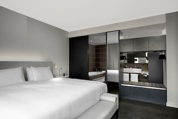 a bedroom with a bed and a mirror
