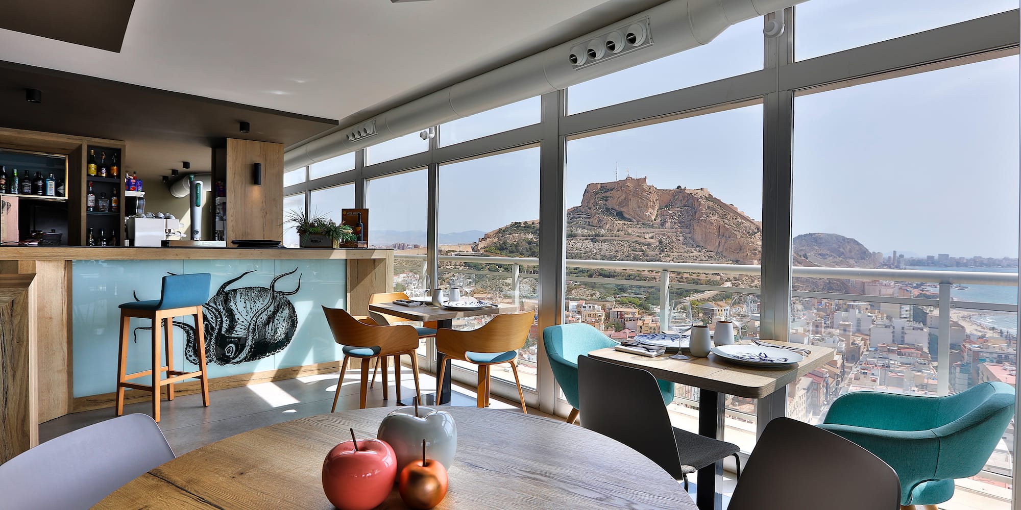 a room with a view of a city and mountains