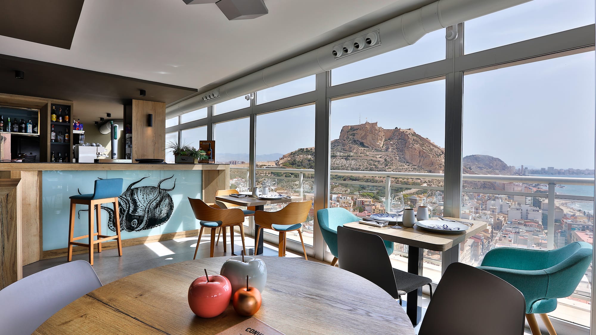 a room with a view of a city and mountains