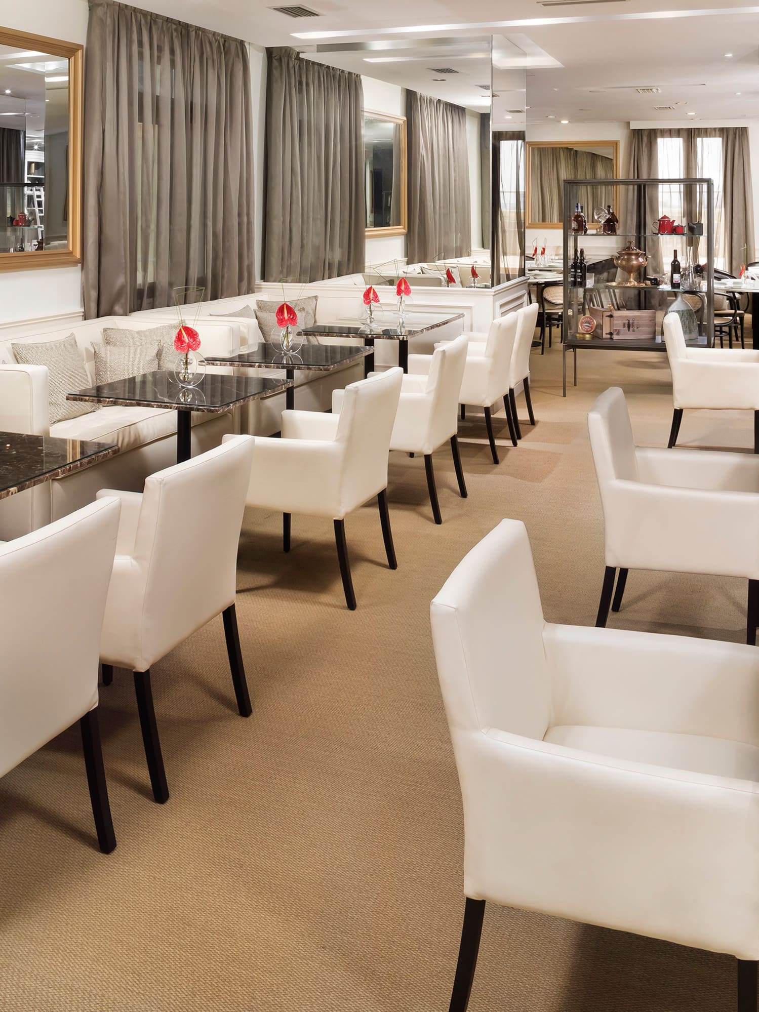 a room with white chairs and tables