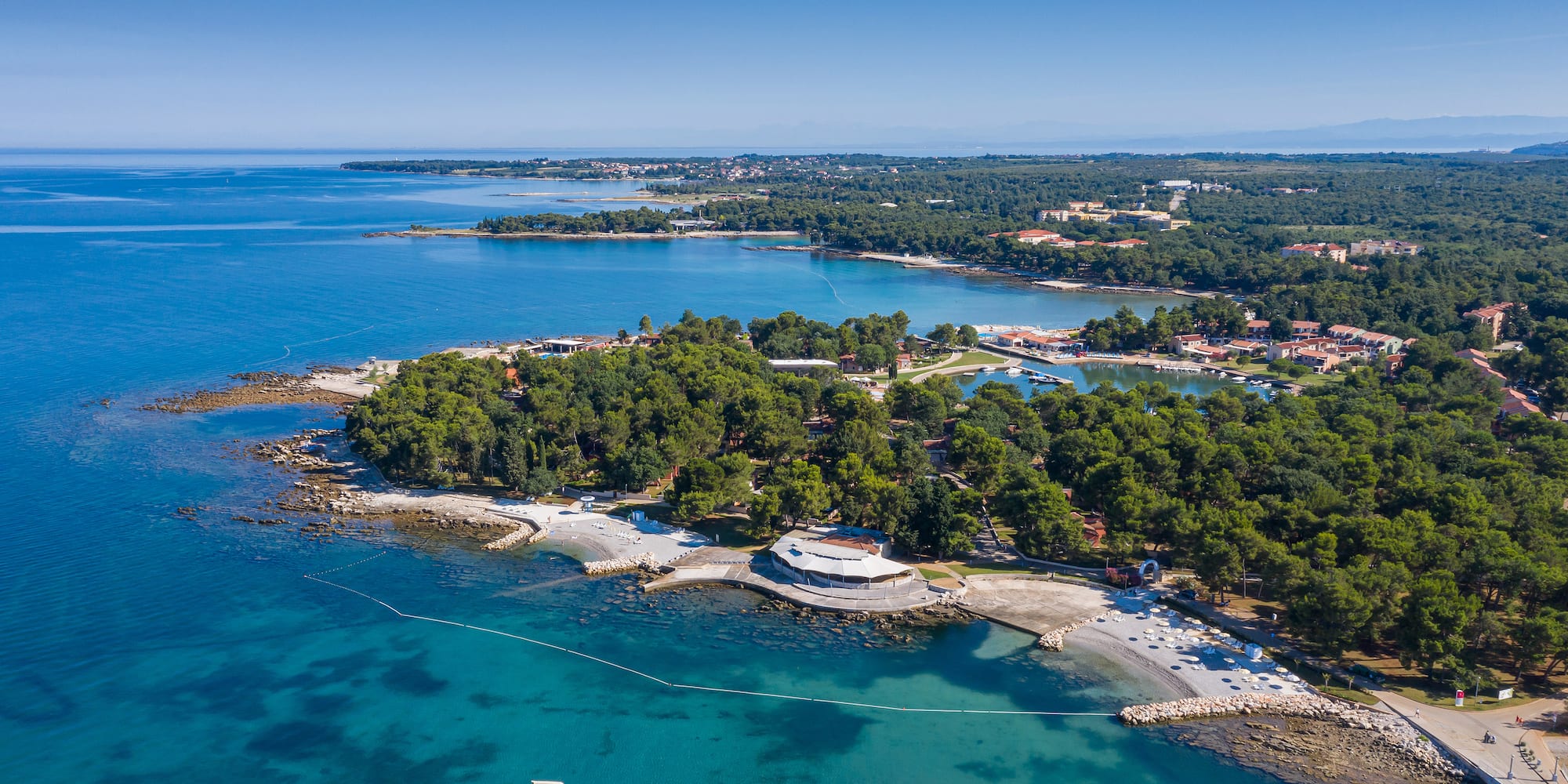 an aerial view of a small island with trees and water