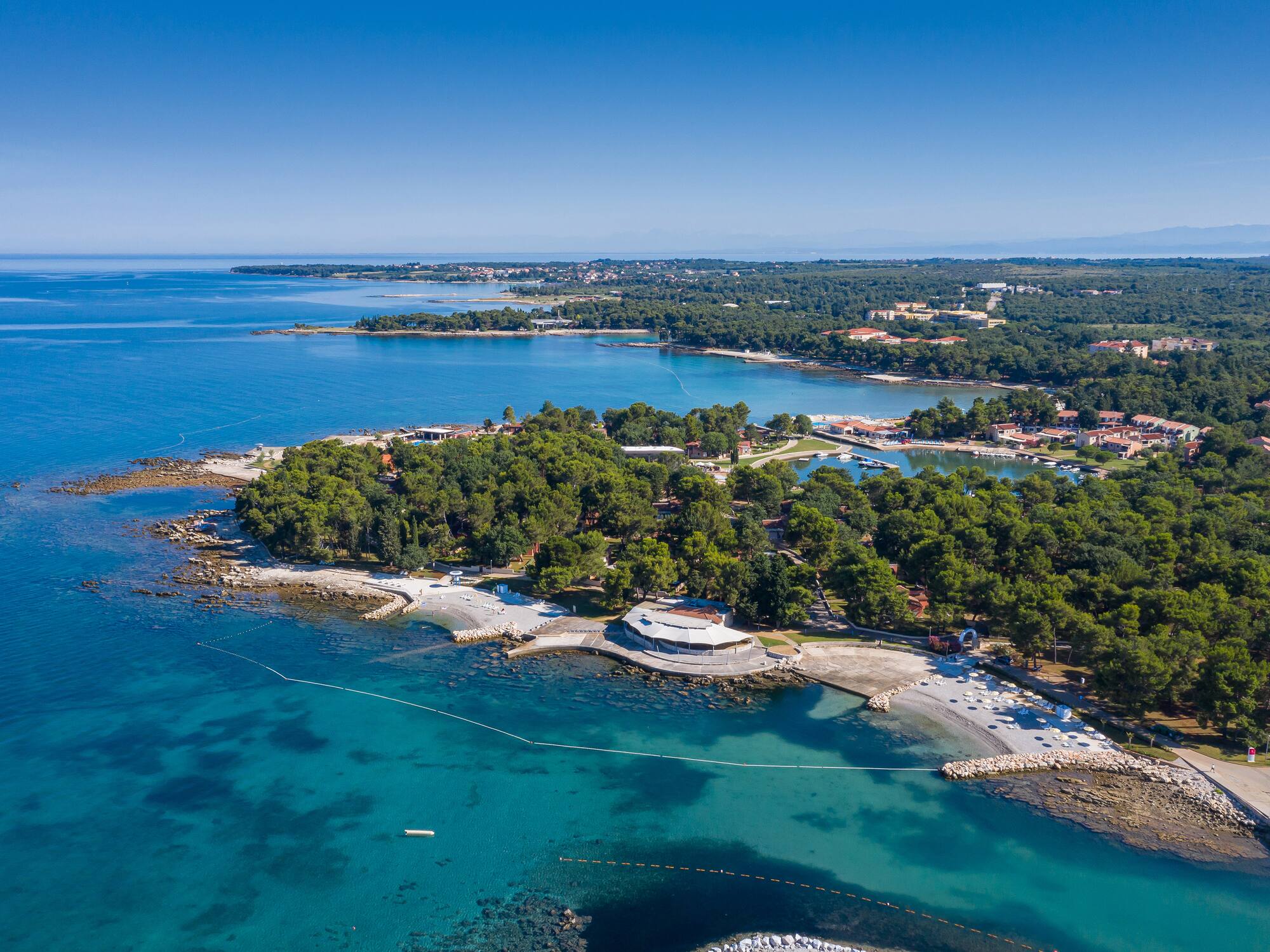 an aerial view of a small island with trees and water