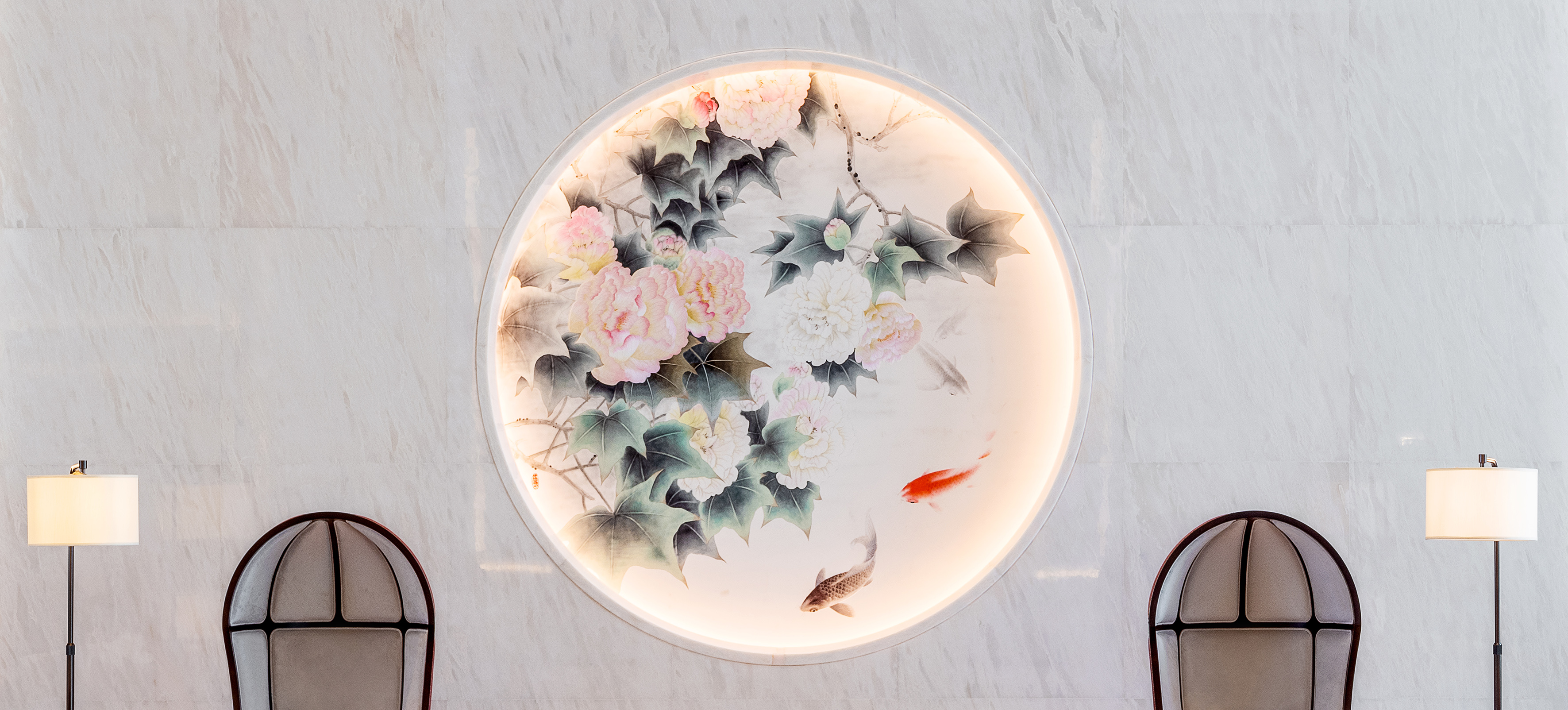 Chinese circular art: backlit peonies & koi fish on white marble.