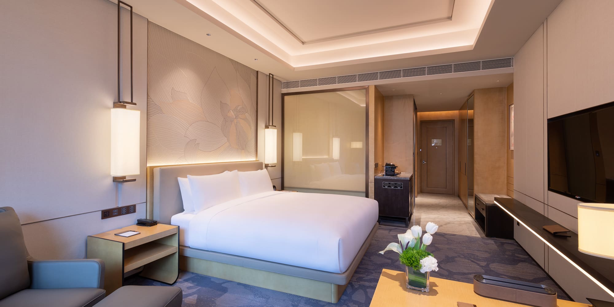 a room with a bed and a tv