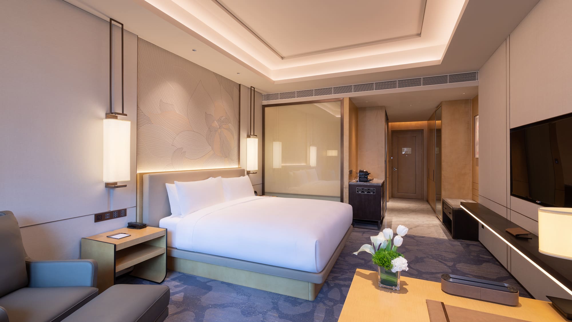 a room with a bed and a tv