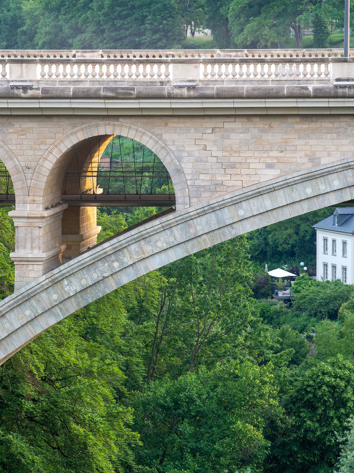 a bridge with arches and trees