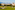 Lush green golf course, Mediterranean resort town, and distant mountains.