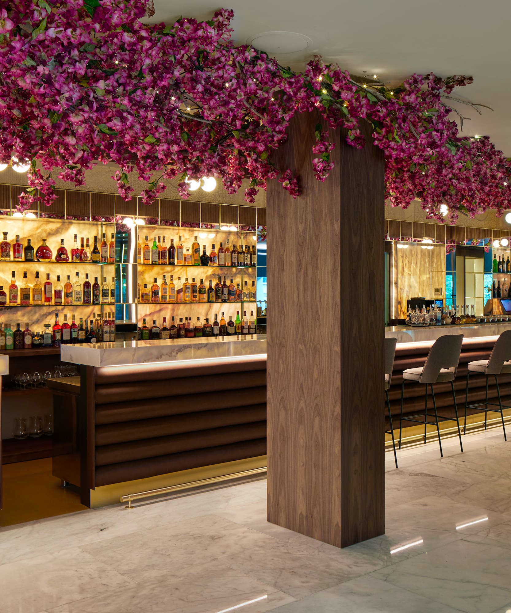 a bar with purple flowers from the ceiling