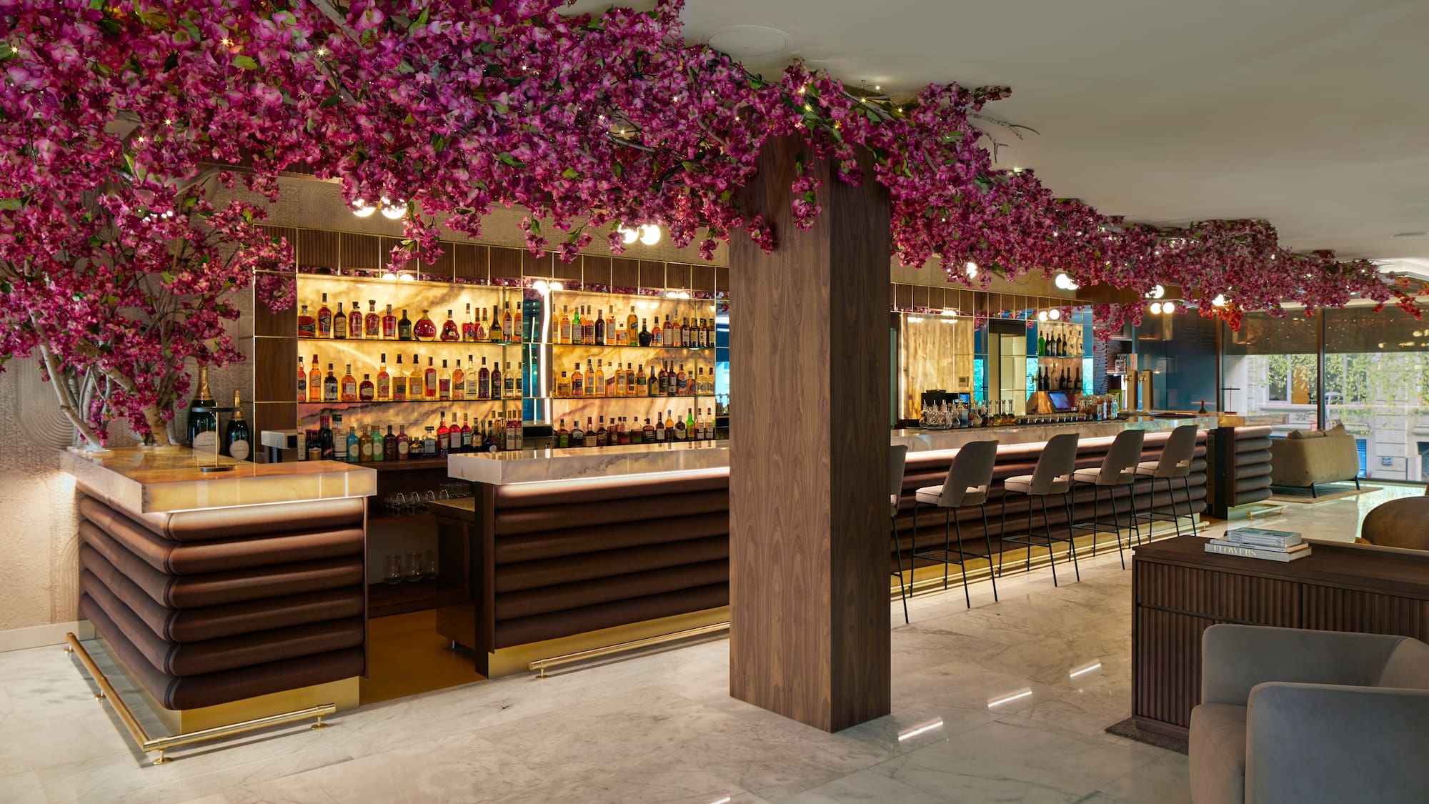 a bar with purple flowers from the ceiling