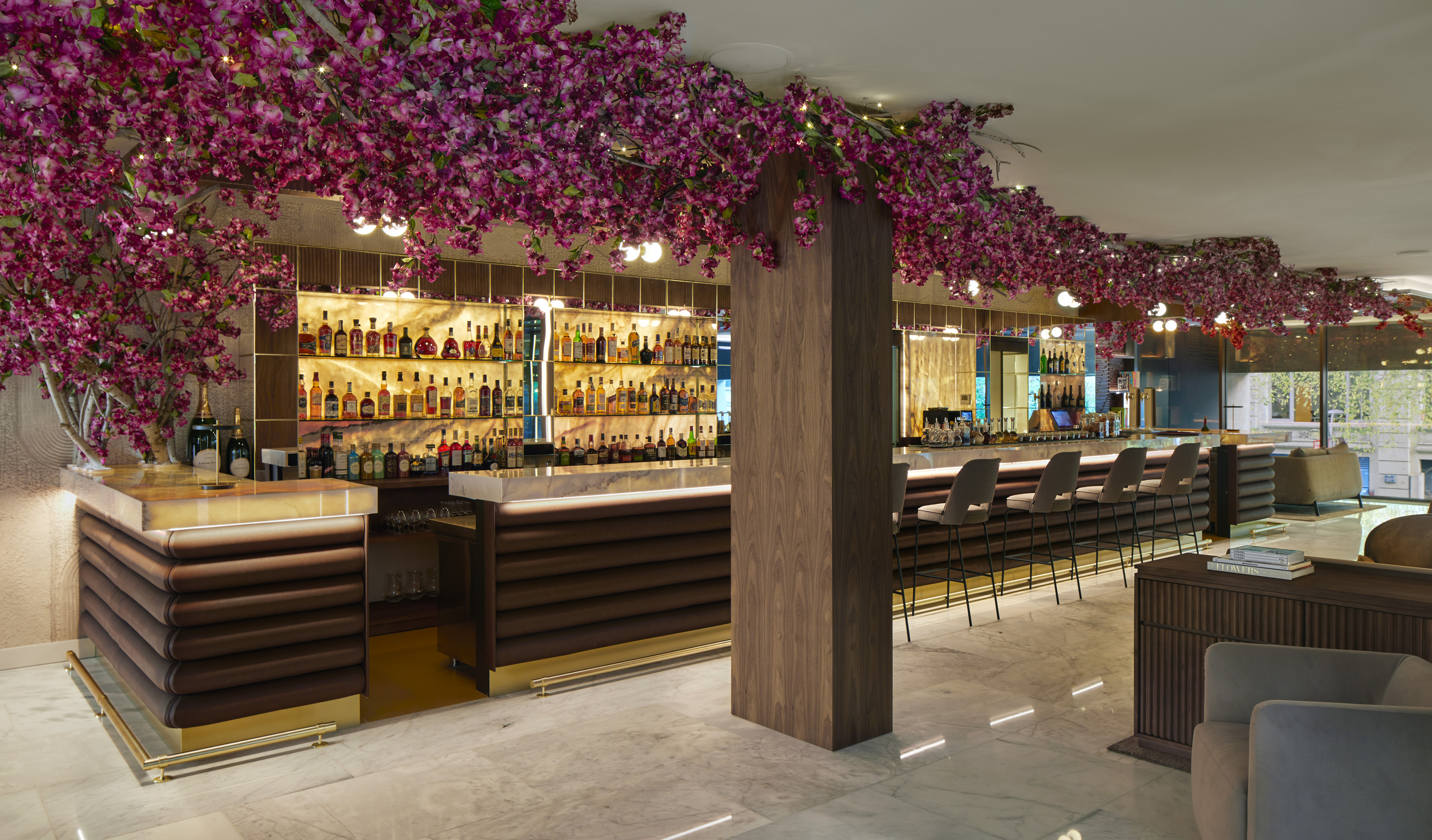 a bar with purple flowers from the ceiling