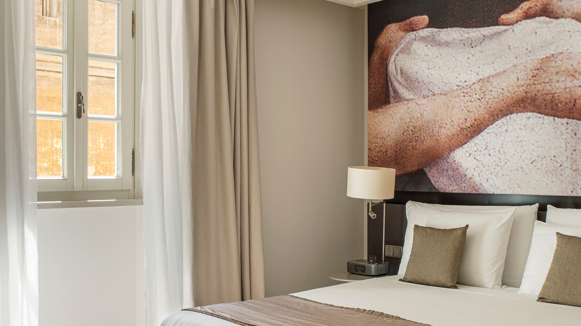 a bed with a picture on the wall