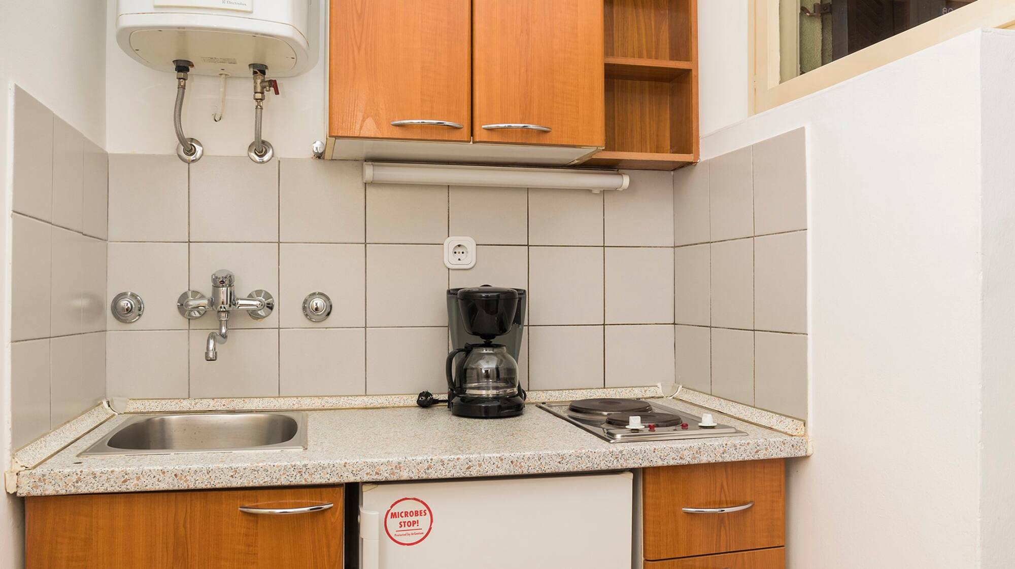 a kitchen with a sink and a coffee maker
