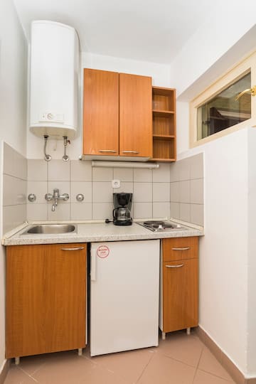 a kitchen with a sink and a coffee maker