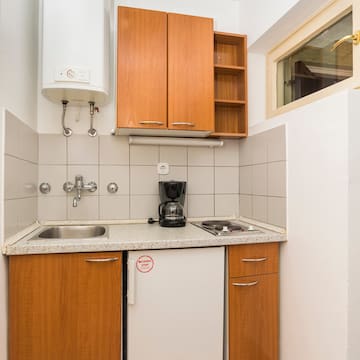 a kitchen with a sink and a coffee maker