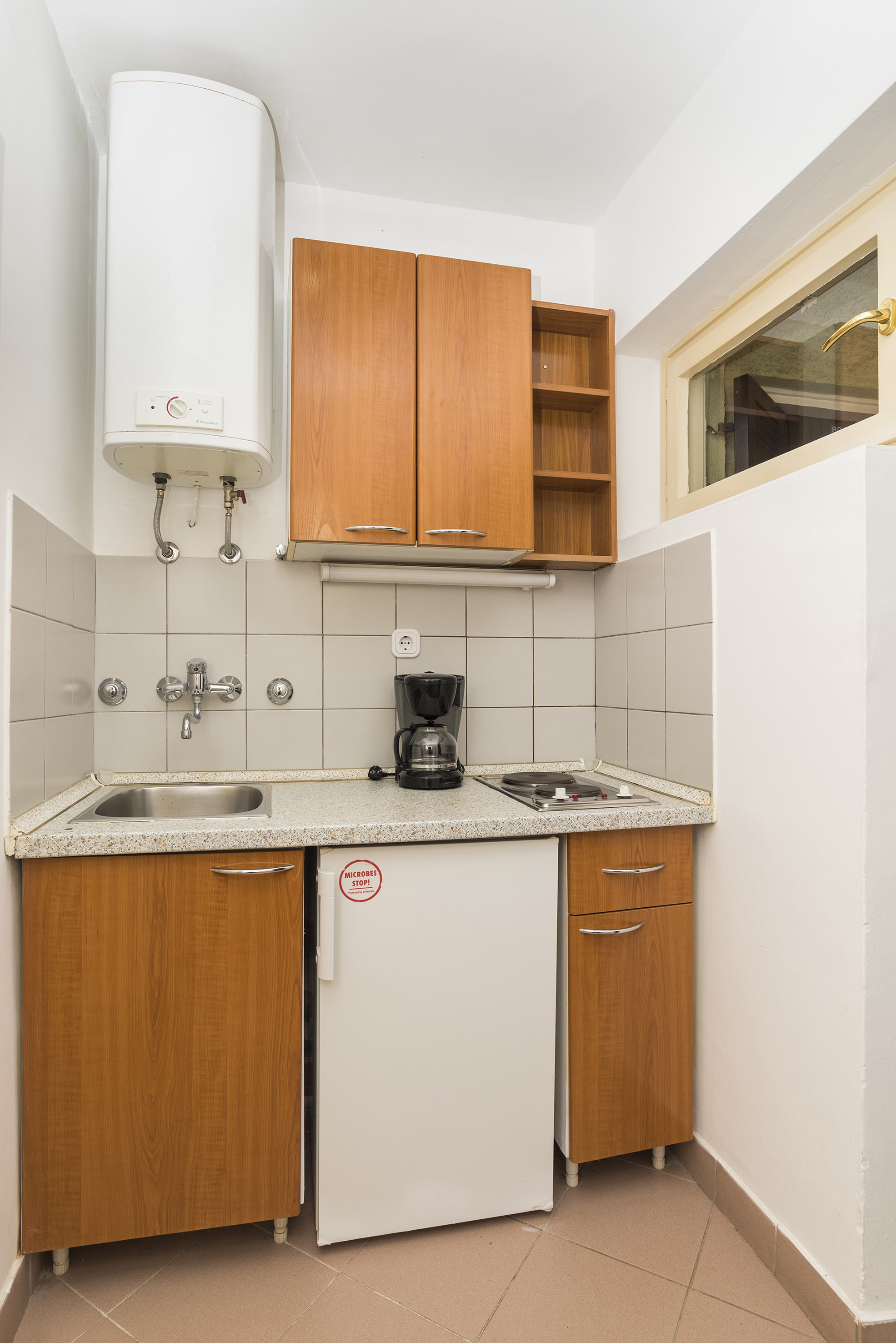 a kitchen with a sink and a coffee maker