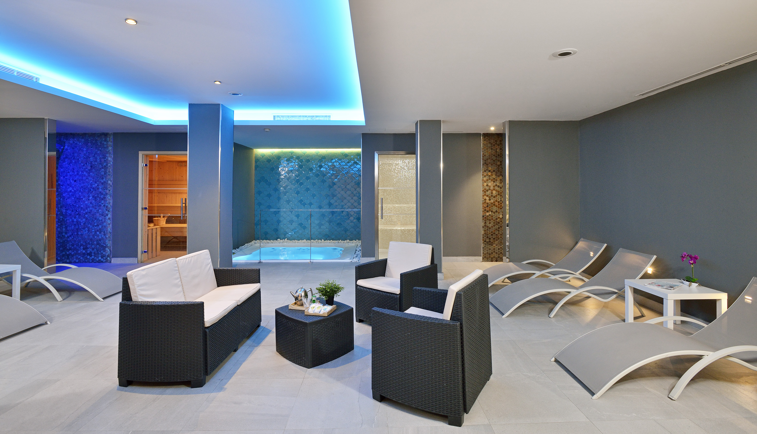 a room with chairs and a pool