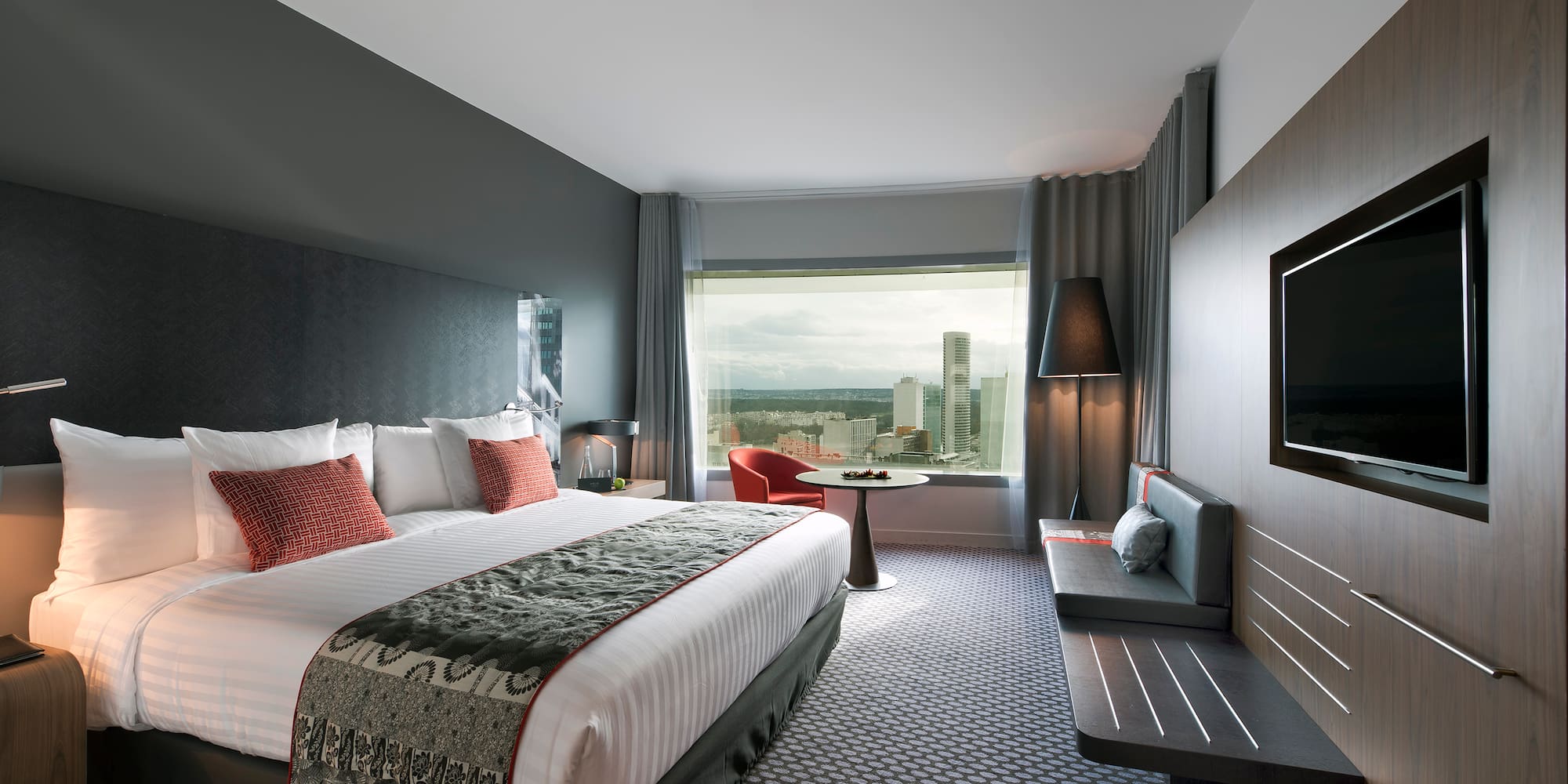 a room with a bed and a television