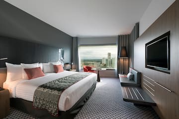 a room with a bed and a television
