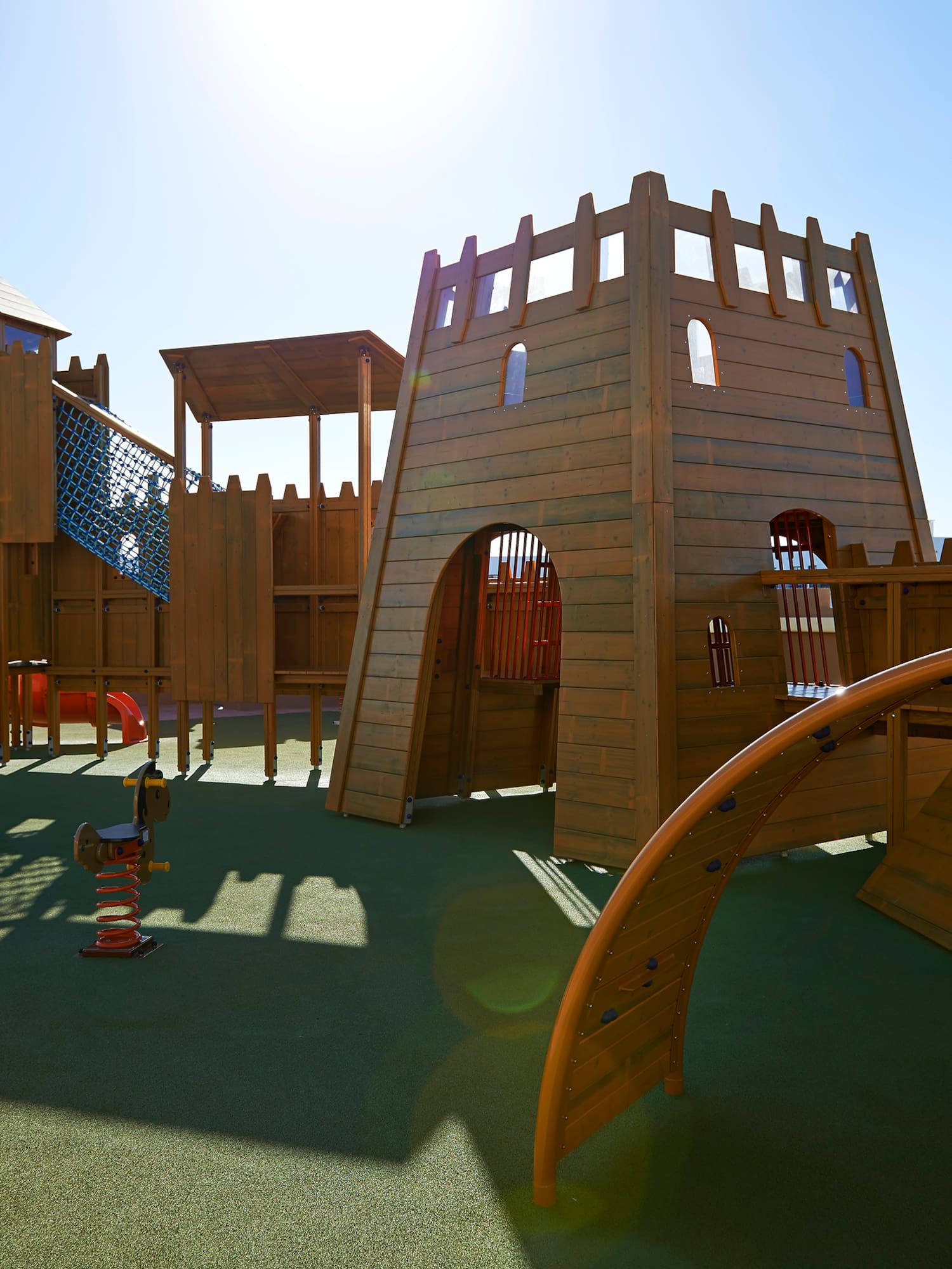 a playground with a structure and a slide