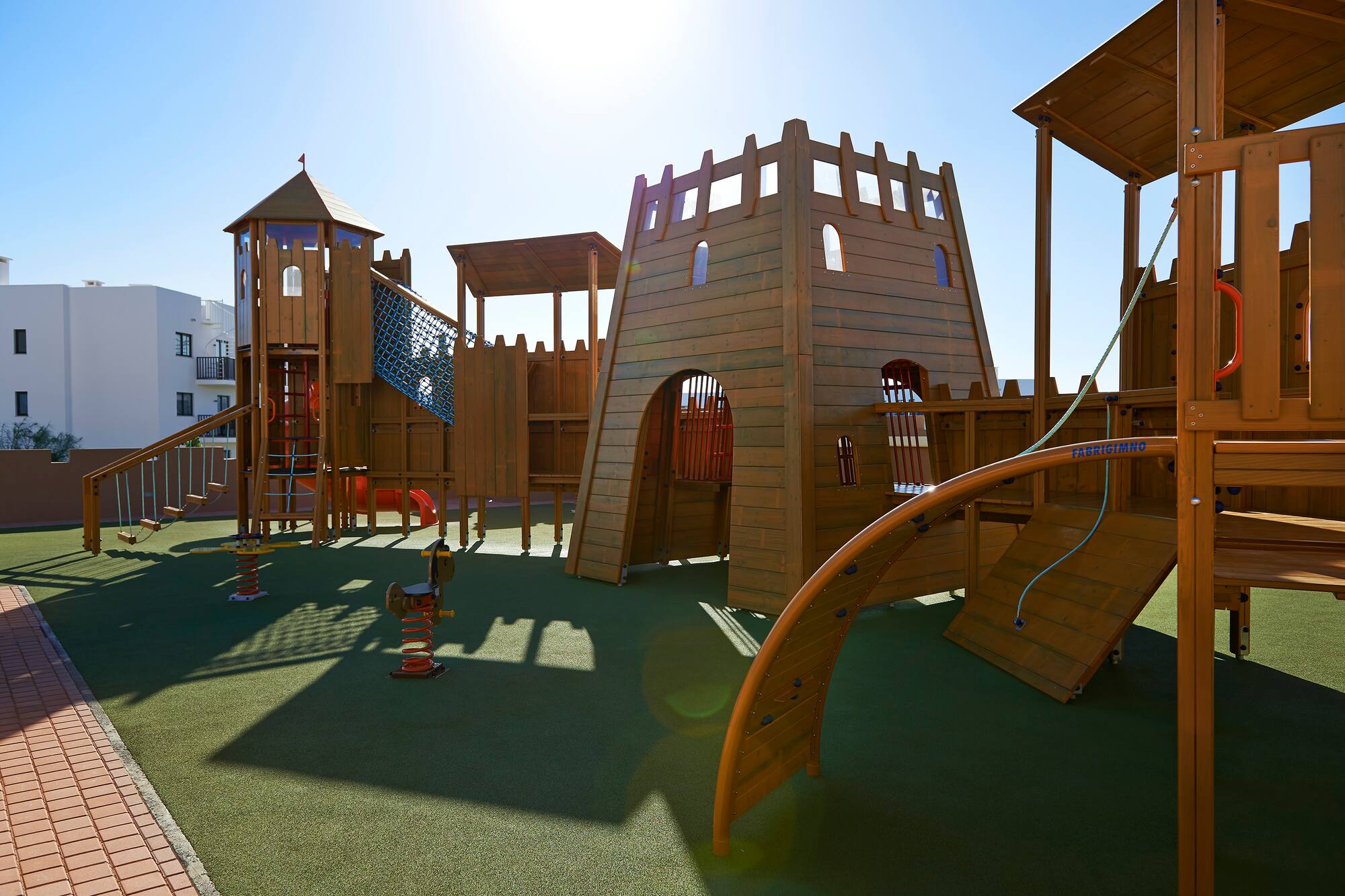 a playground with a structure and a slide