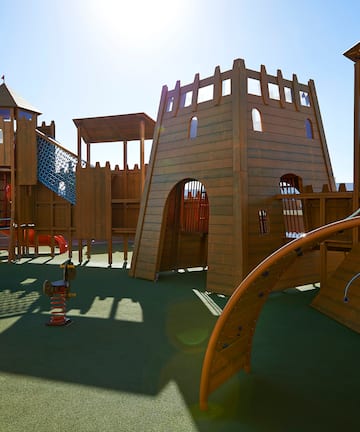 a playground with a structure and a slide