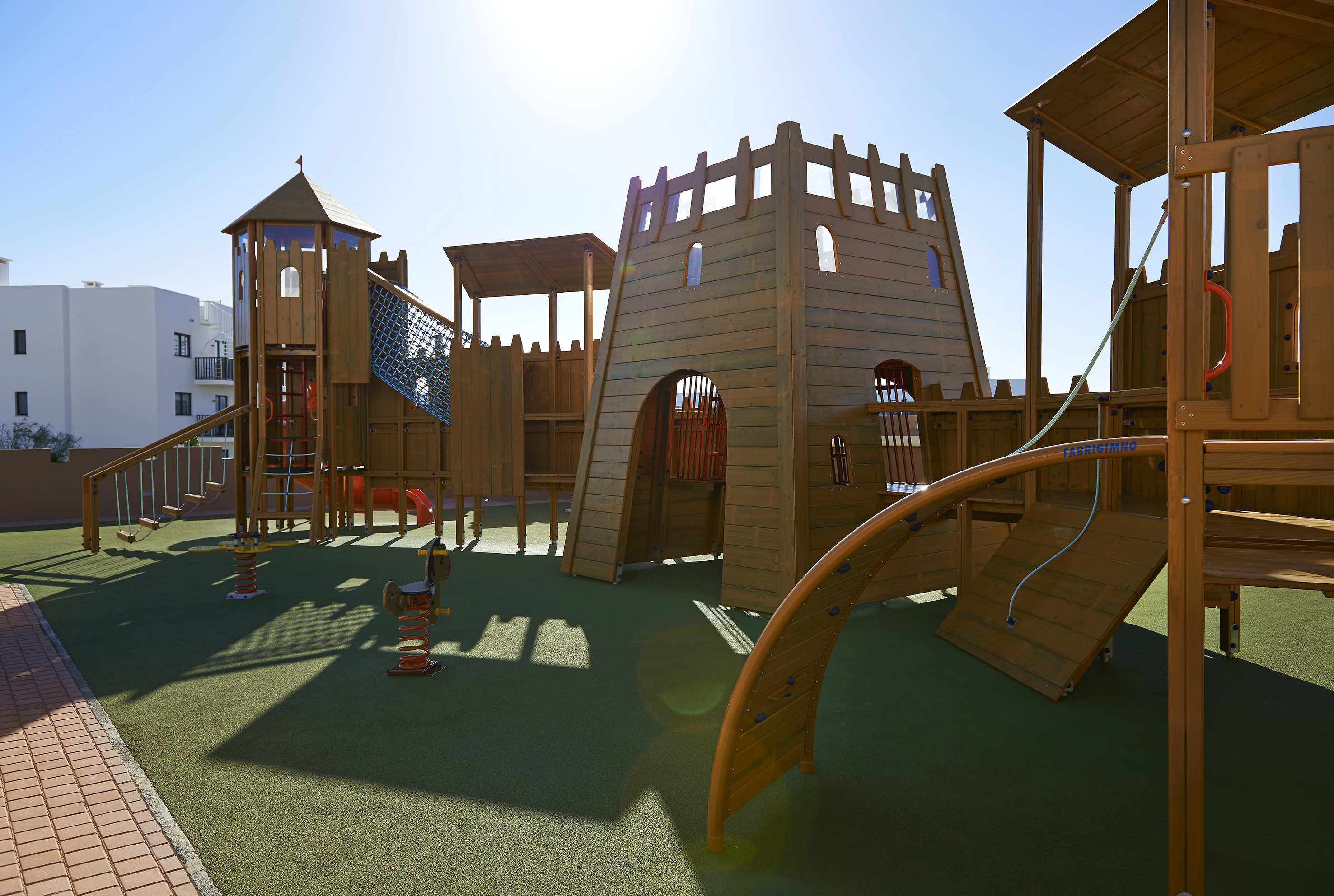 a playground with a structure and a slide