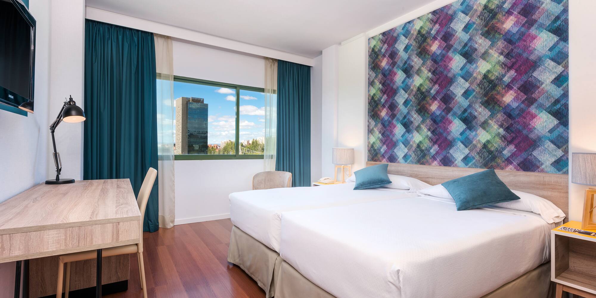 a room with two beds and a table