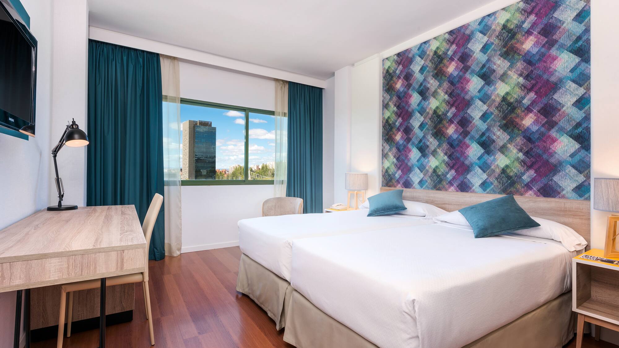 a room with two beds and a table