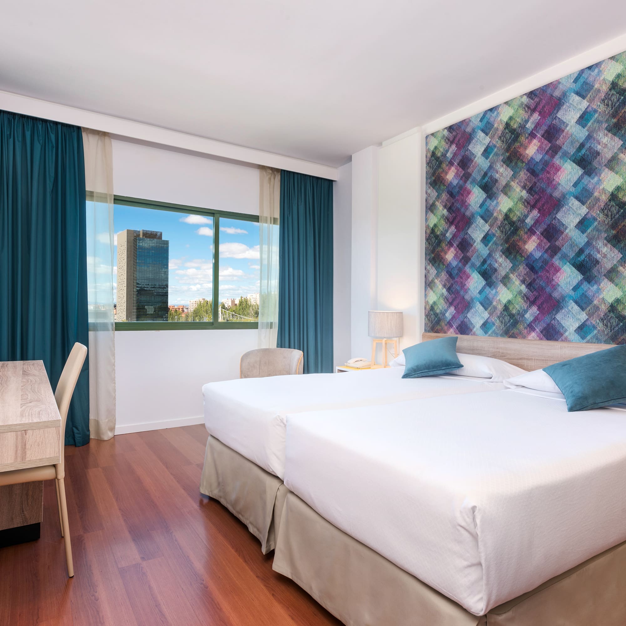 a room with two beds and a table