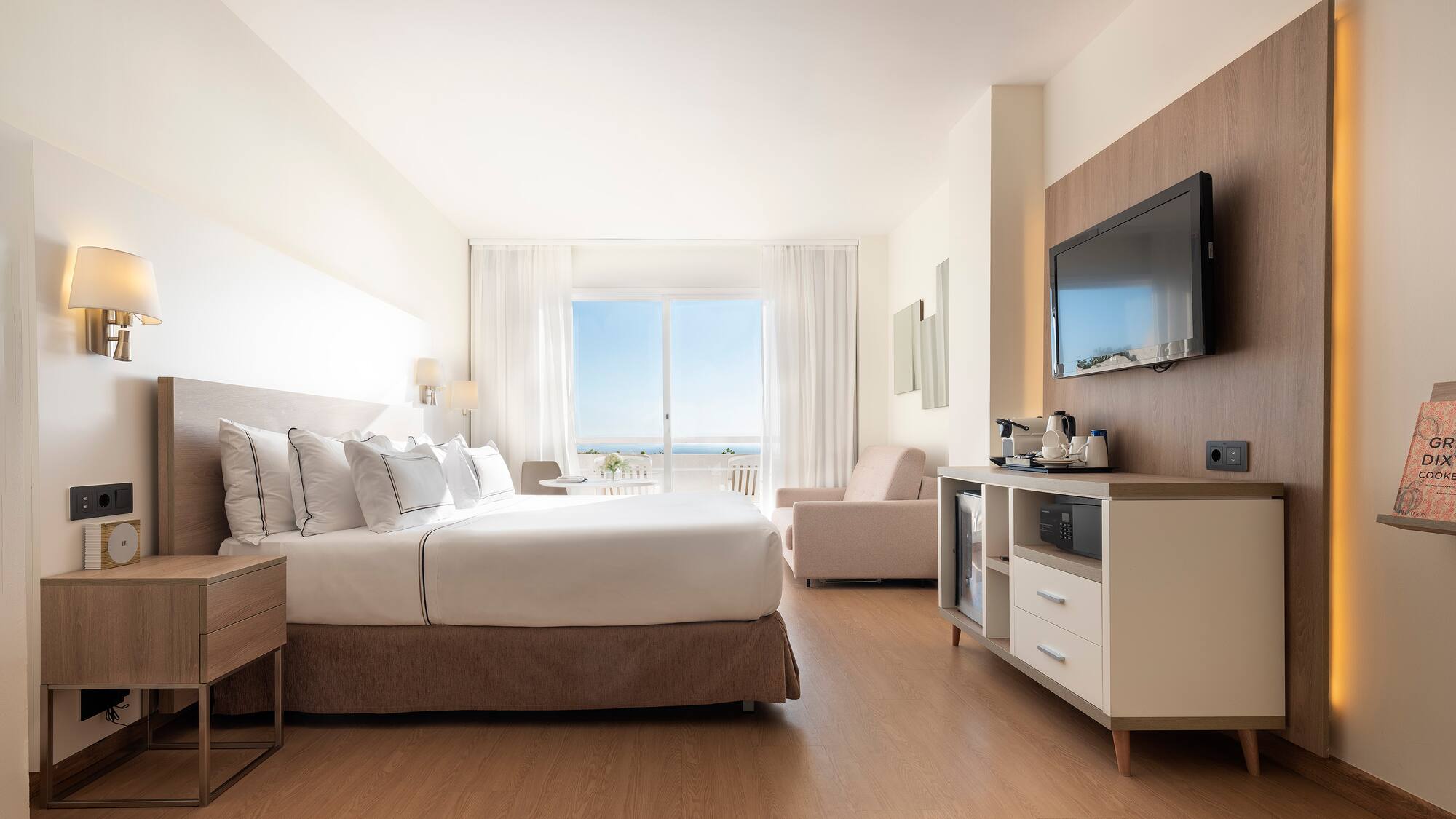 a room with a bed and a television