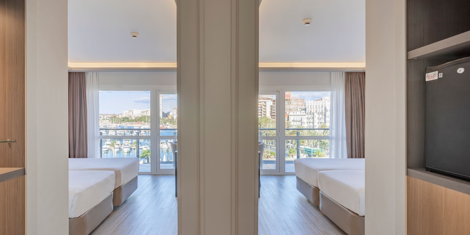 a room with two beds and a window